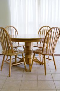 Sunlight streaming through curtains onto solid oak table and chairs. Photo by Charles Coleman