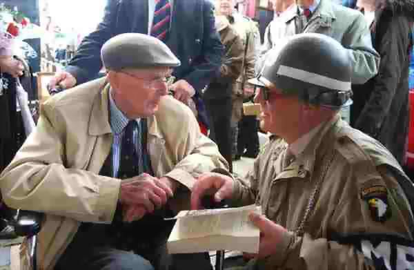 Douglas (left) signing a book for U.S. Military Policeman Gary Poole of Grimsby at Ludborough station.